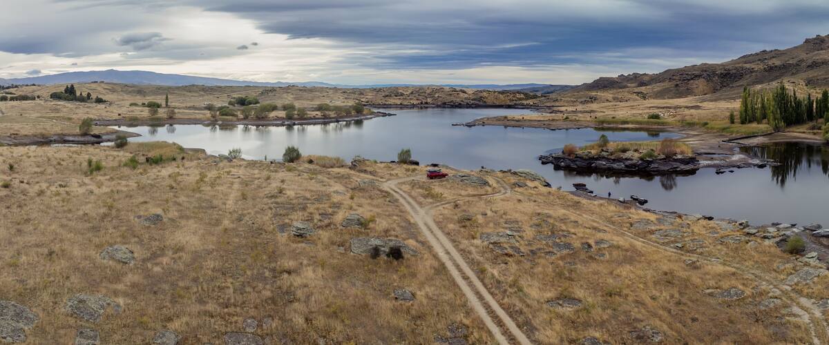 Dry farmland and Butchers Creek reservoir, Alexandra, Otago, New Zealand.