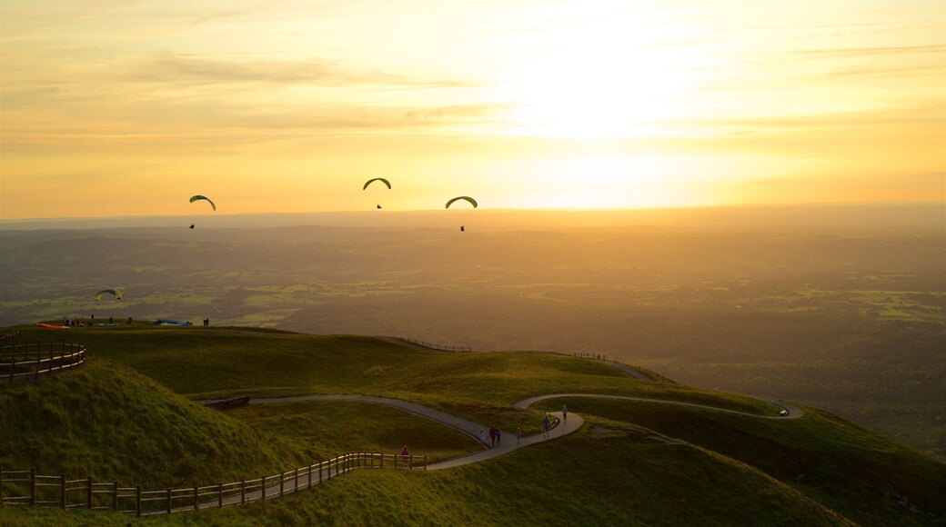 Puy de Dome which includes skydiving, a sunset and tranquil scenes