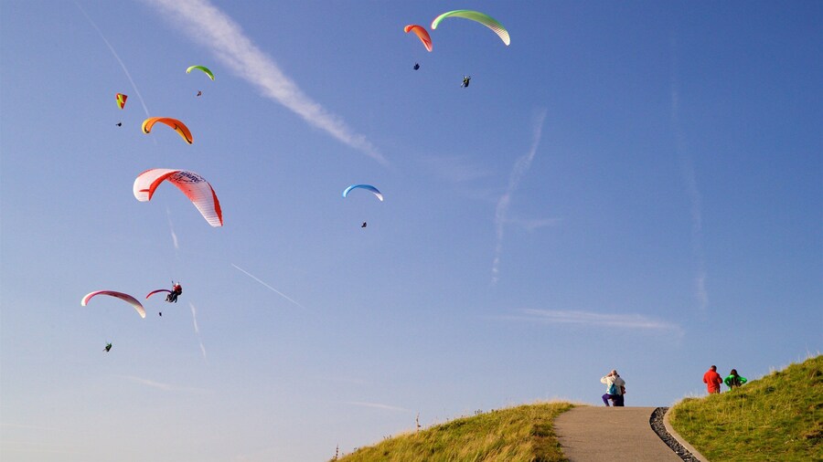 Puy de Dome showing landscape views and skydiving as well as a small group of people