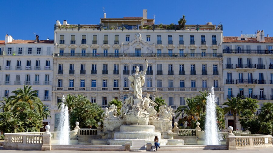 Place de la Liberte showing a square or plaza, a statue or sculpture and a fountain