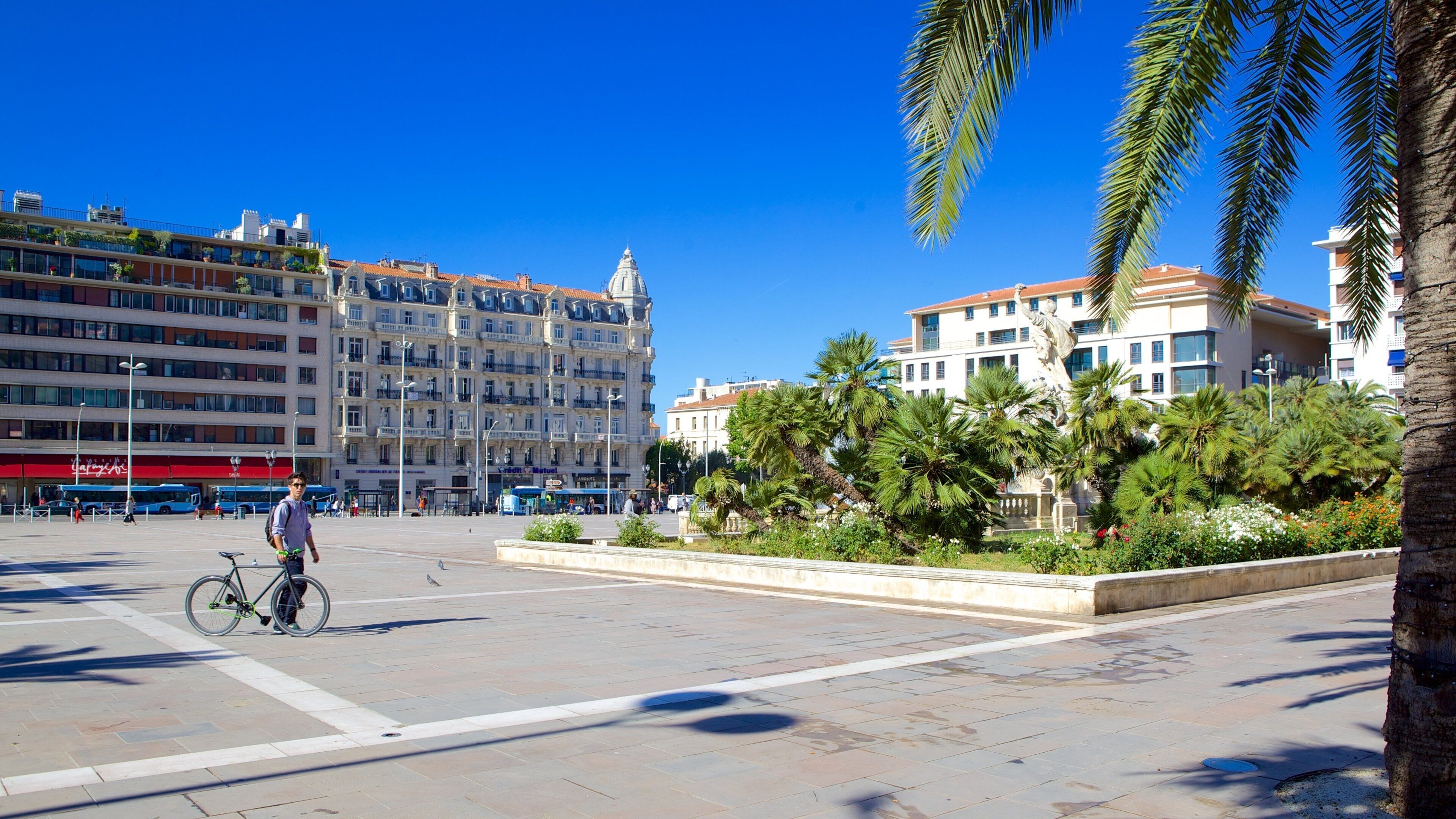 Place de la Liberte showing cycling and a square or plaza as well as an individual male