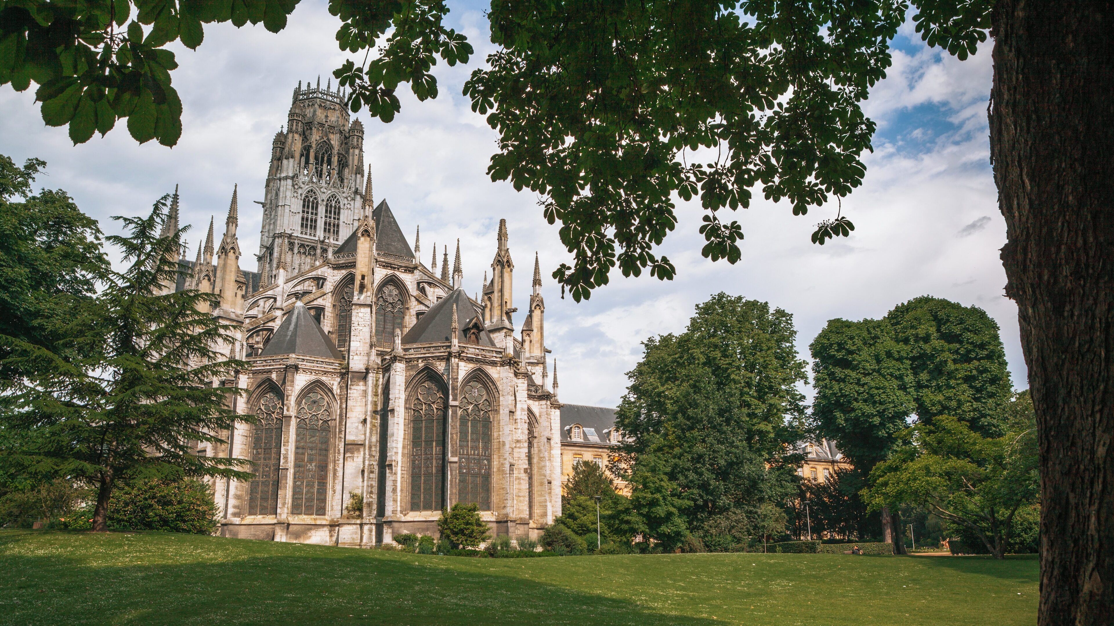 Saint-Ouen Church stands majestically in Rouen City Centre surrounded by lush greenery in Normandy, France, inviting visitors to admire its stunning architectural details and history