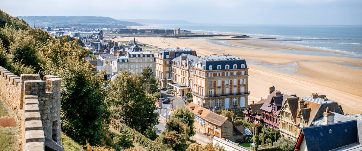 Luxury houses on the coastline with beautiful beach on the background in Trouville, famous french town in Normandy