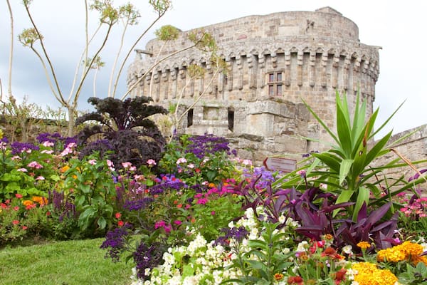 Chateau de Dinan featuring a park, heritage architecture and flowers