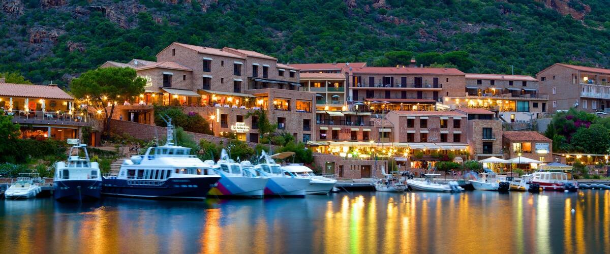 Porto Beach which includes a marina, a coastal town and a sunset