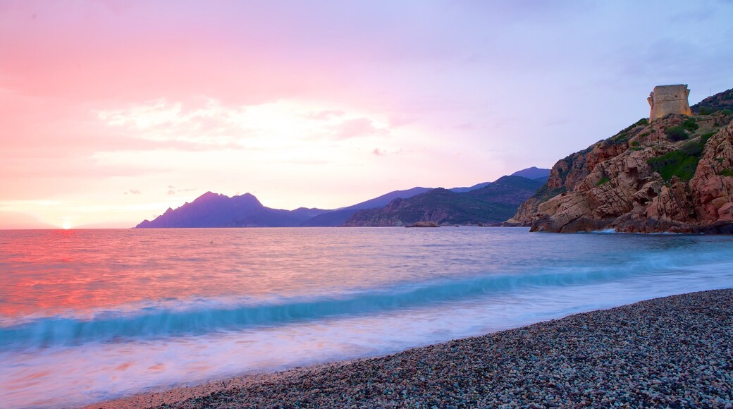 Genoese Tower which includes a sunset and a pebble beach