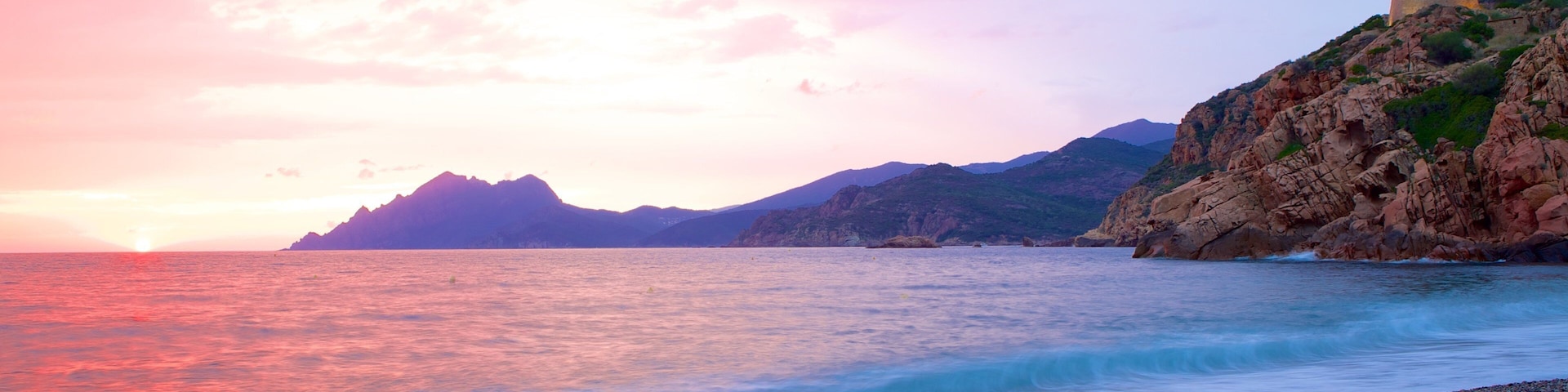 Genoese Tower which includes a sunset and a pebble beach