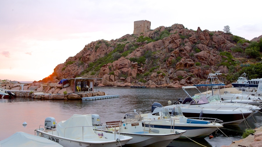 Genoese Tower featuring rugged coastline, a sunset and a bay or harbor