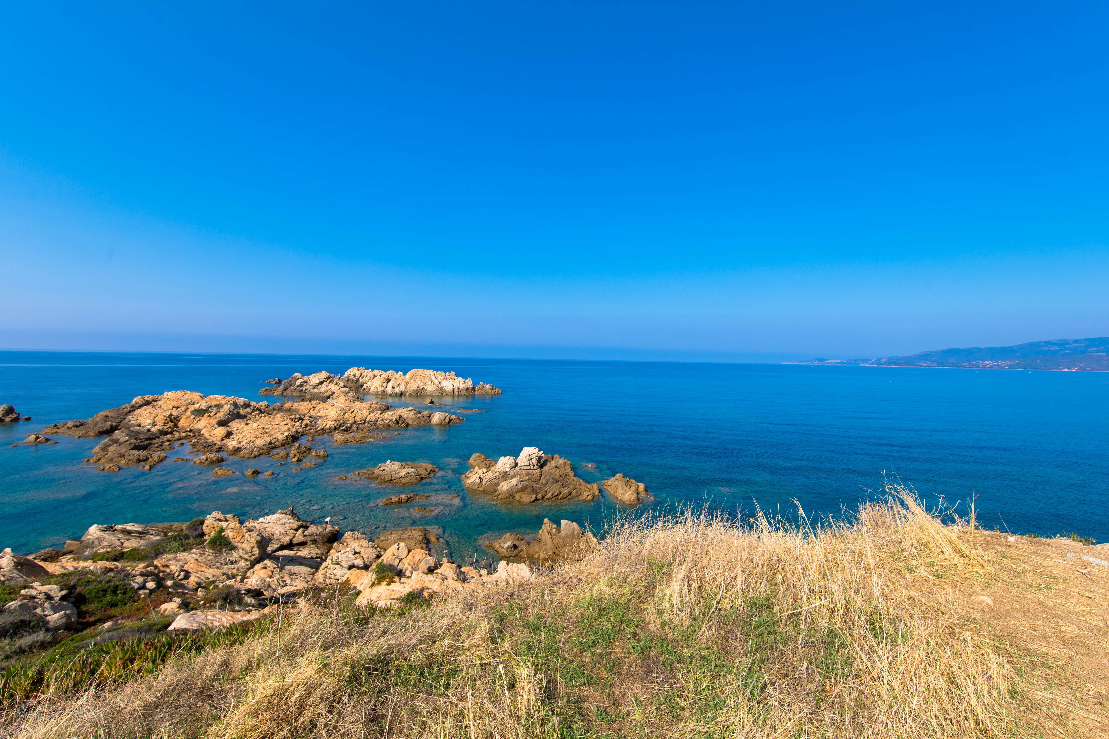 Beautiful beach with golden sand, rocks and the turquoise Mediterranean Sea, Propriano Beach, Corsica, France
