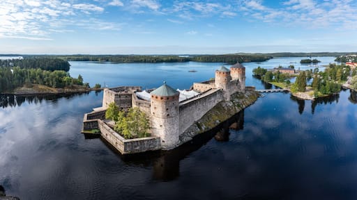 Aerial panorama of Olavinlinna castle and the surrounding lakes in Savonlinna, Finland.