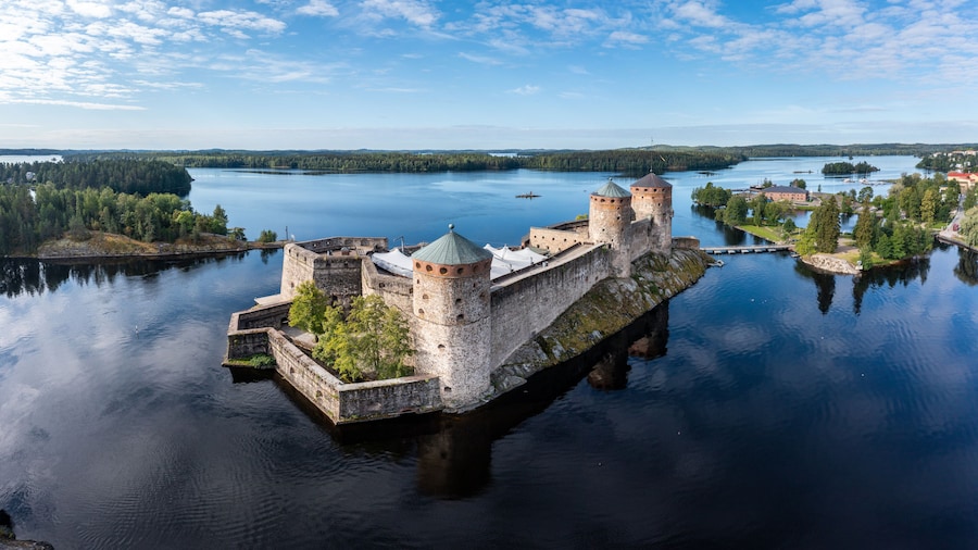 Aerial panorama of Olavinlinna castle and the surrounding lakes in Savonlinna, Finland.