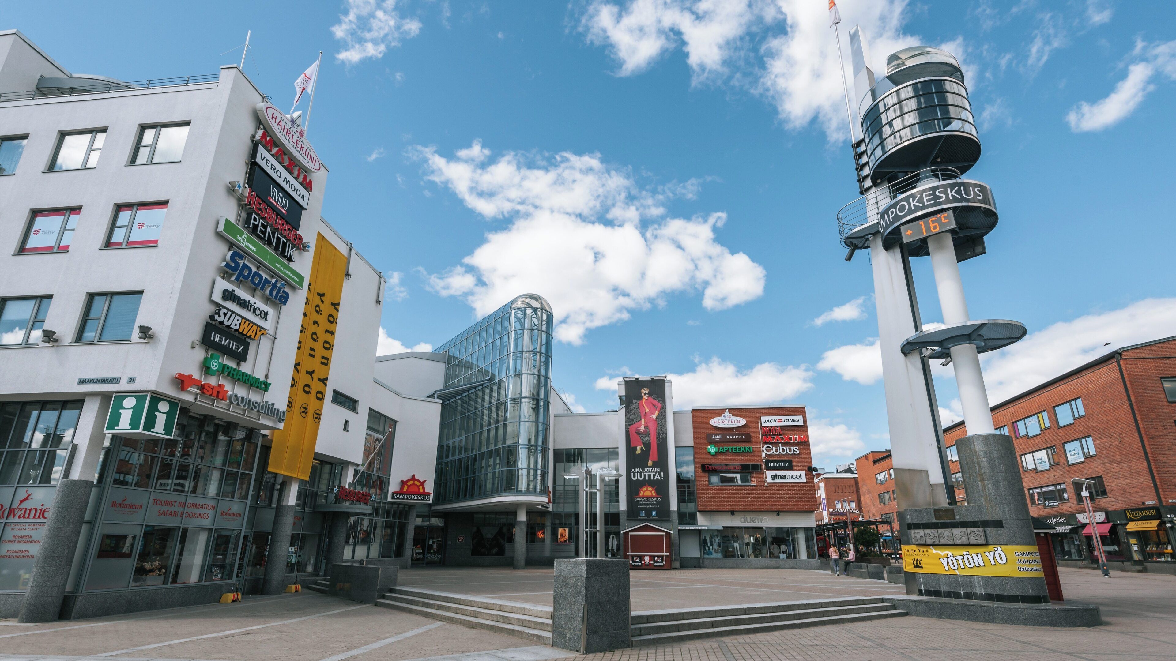 Vibrant atmosphere of Lordi's Square in Rovaniemi, Lapland, Finland, showcasing modern architecture and festive spirit during the summer months