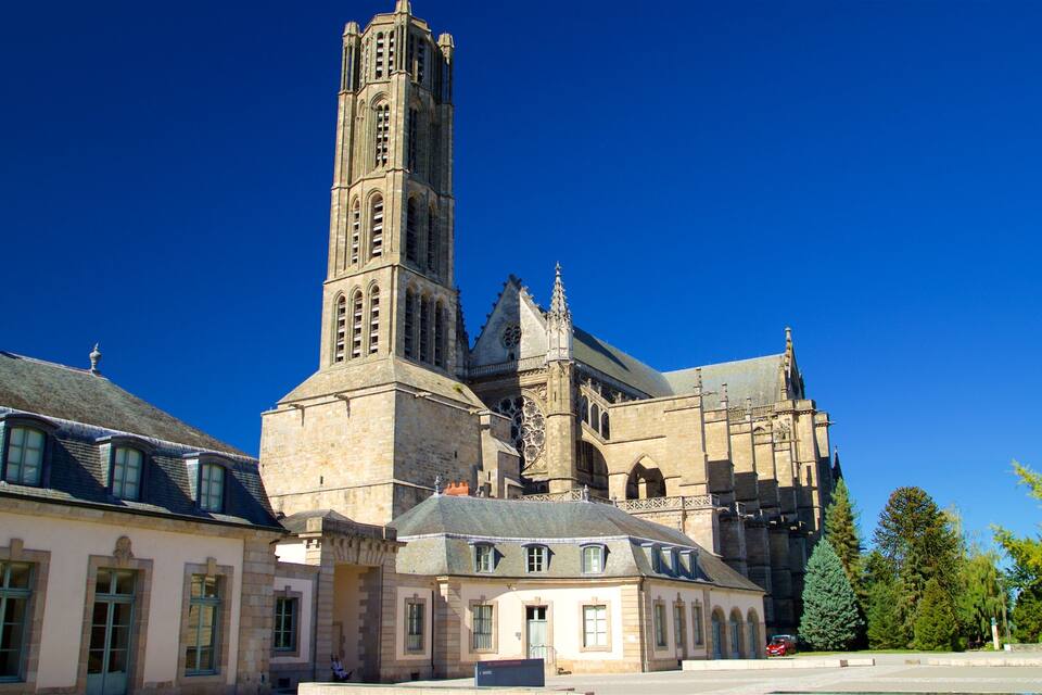 A historic church with a tall bell tower and adjacent buildings.