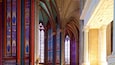 A cathedral interior with stained glass windows and Gothic arches.