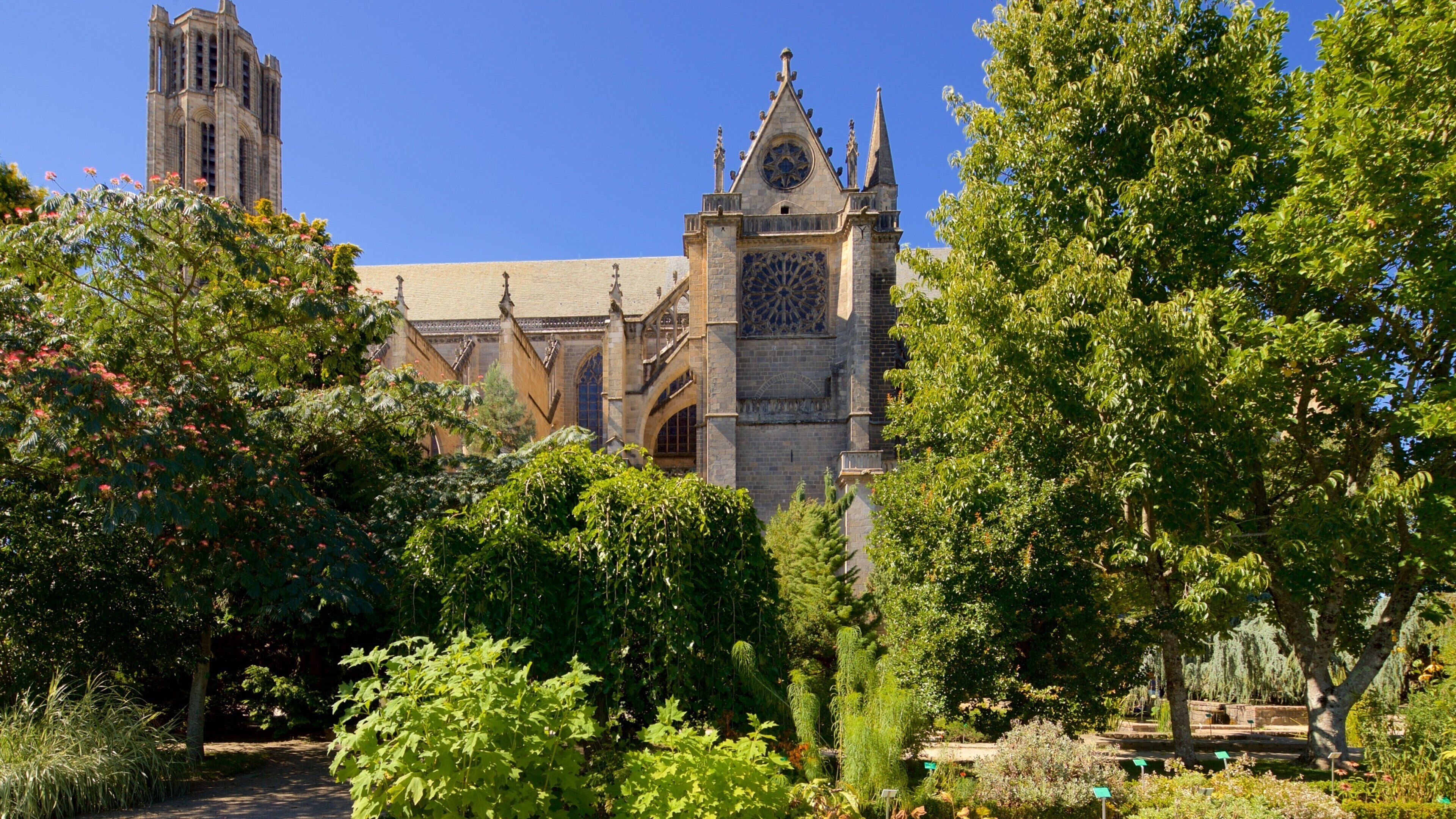 Jardin de l\'Eveche featuring a church or cathedral and heritage architecture