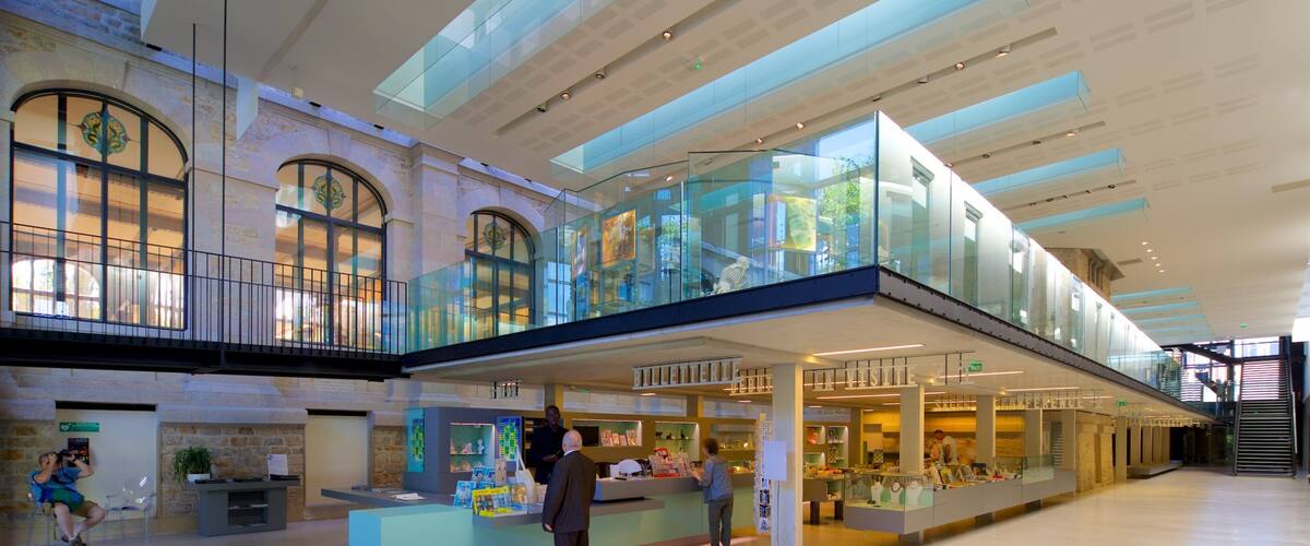 Musee National Adrien Dubouche featuring interior views as well as a small group of people