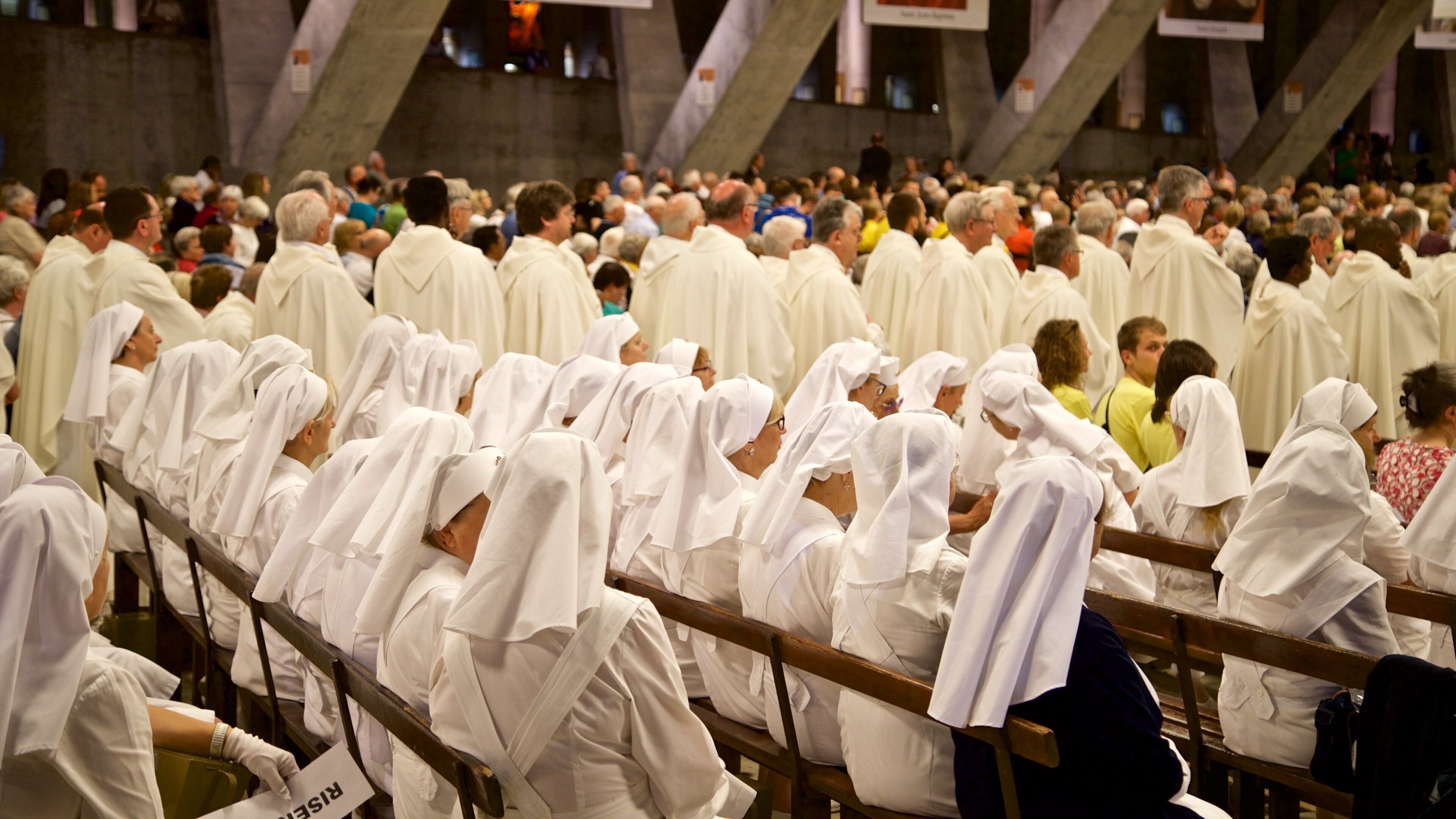 Basilica of St. Pius X featuring a church or cathedral and interior views as well as a large group of people