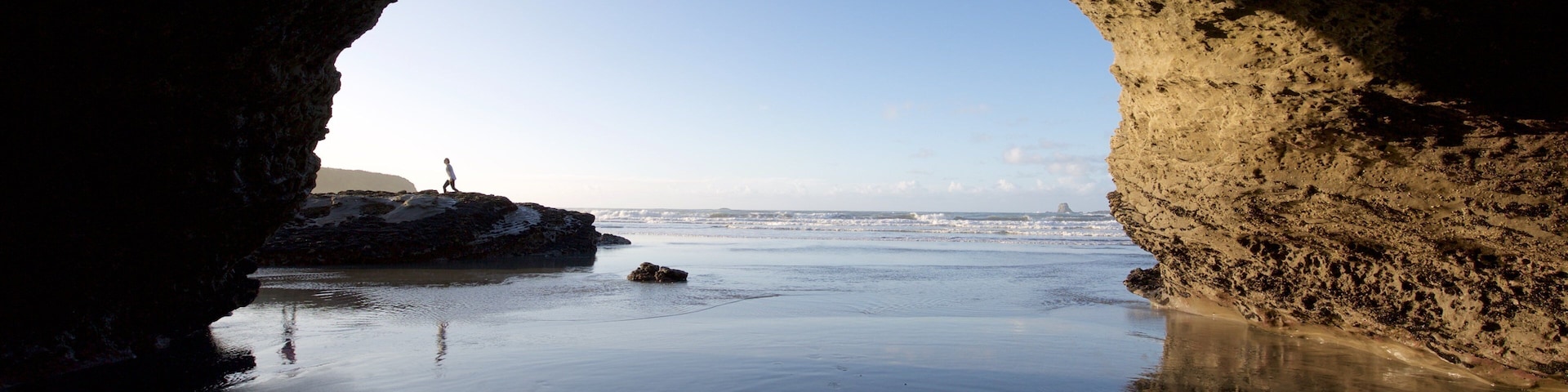 Westport showing surf, a beach and rocky coastline
