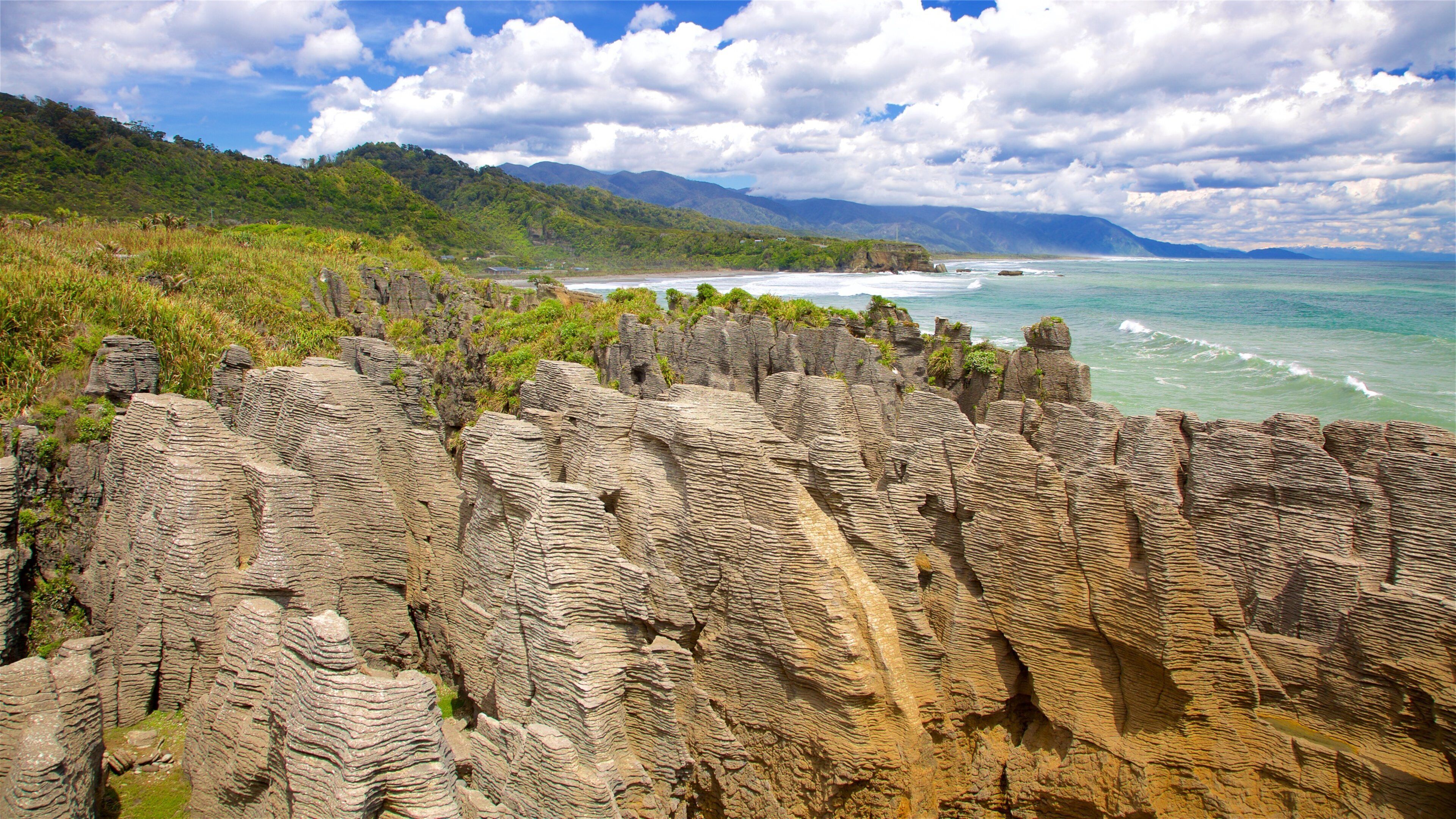 Pancake Rocks featuring rocky coastline, a bay or harbor and waves