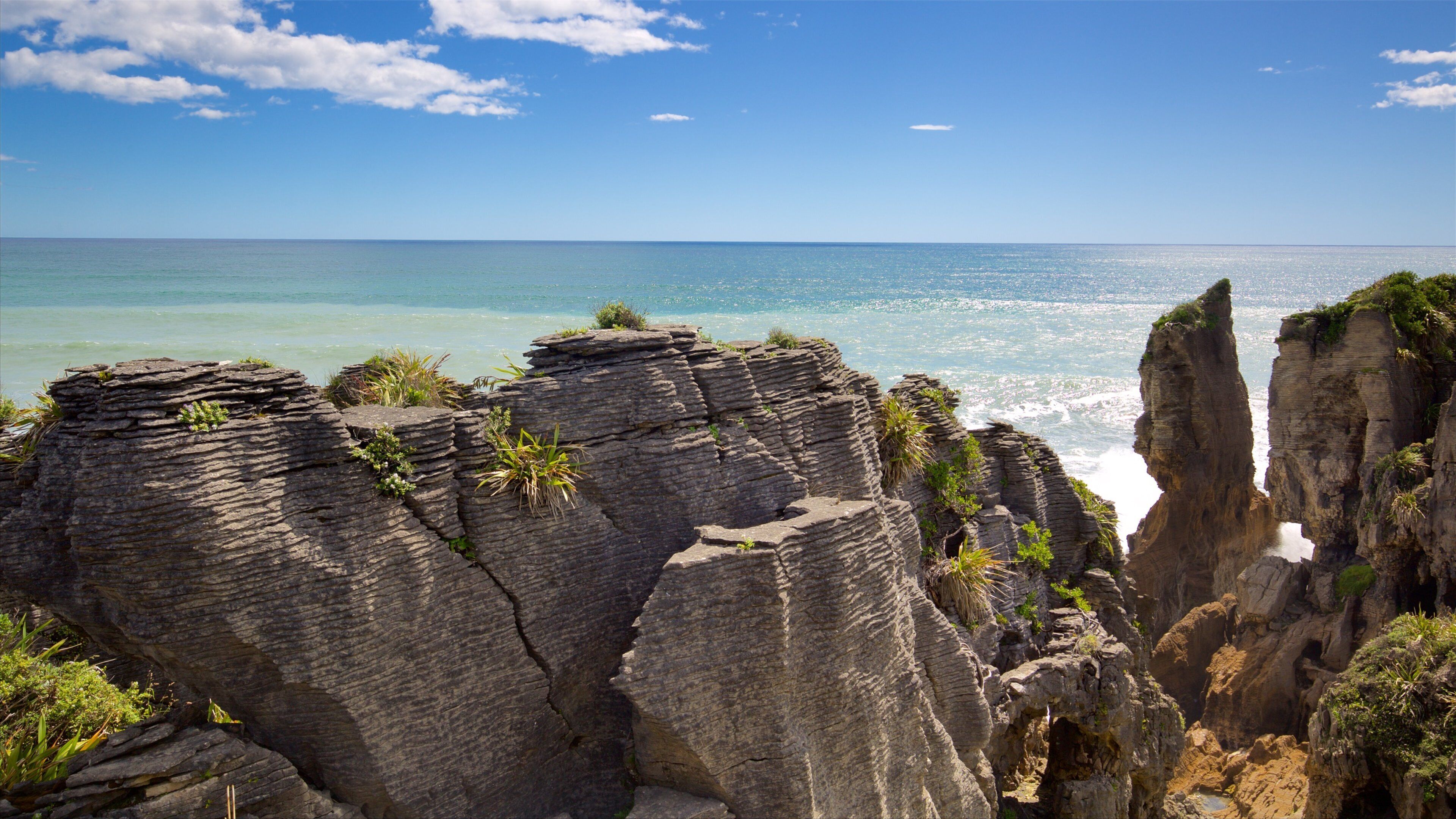 Pancake Rocks featuring rocky coastline and a bay or harbor