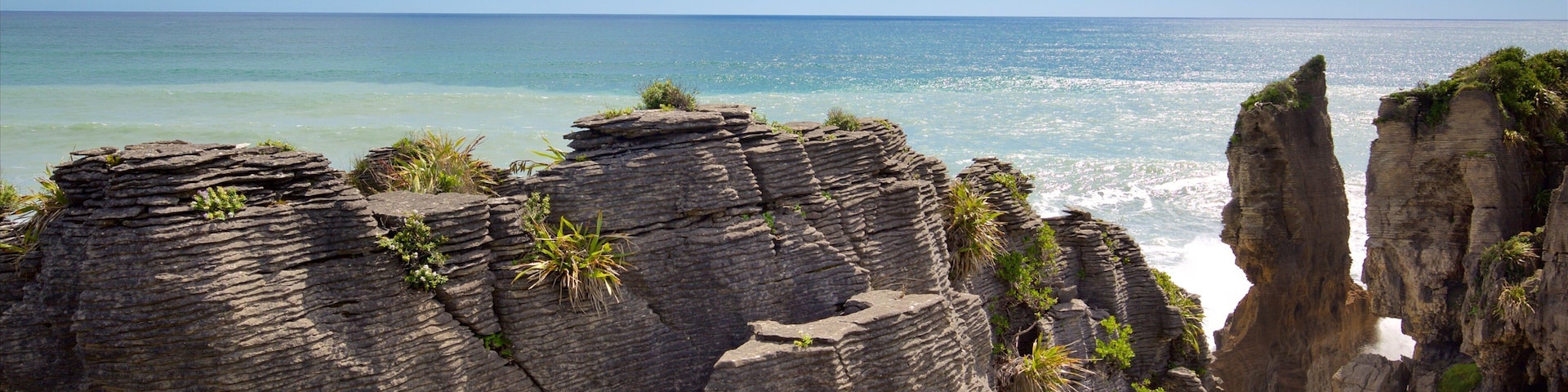 Pancake Rocks featuring a bay or harbour and rocky coastline