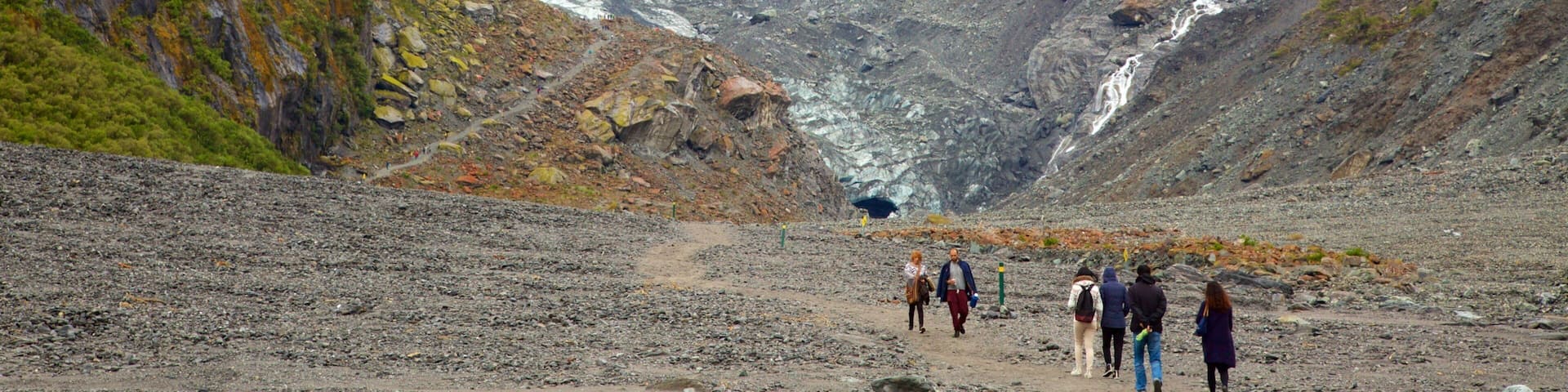 Fox Glacier featuring mist or fog, a cascade and mountains
