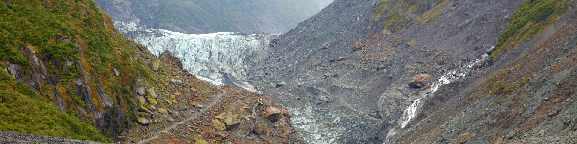 Fox Glacier featuring mist or fog, a cascade and mountains