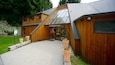 A wooden building with a sign reading "Kiwi Birdlife Park" and a gravel path leading to it.