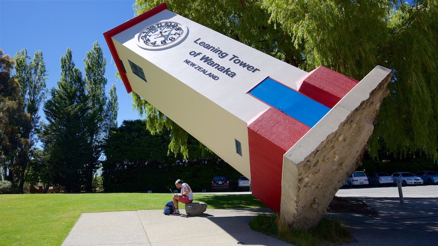 Puzzling World featuring a garden and outdoor art as well as an individual male