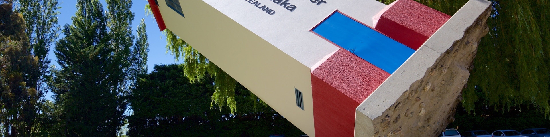 Puzzling World featuring a garden and outdoor art as well as an individual male