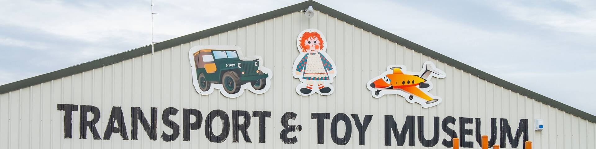 A building with a sign reading "Transport & Toy Museum".