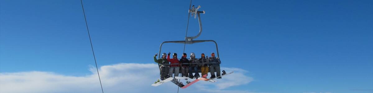 Treble Cone featuring a gondola as well as a small group of people