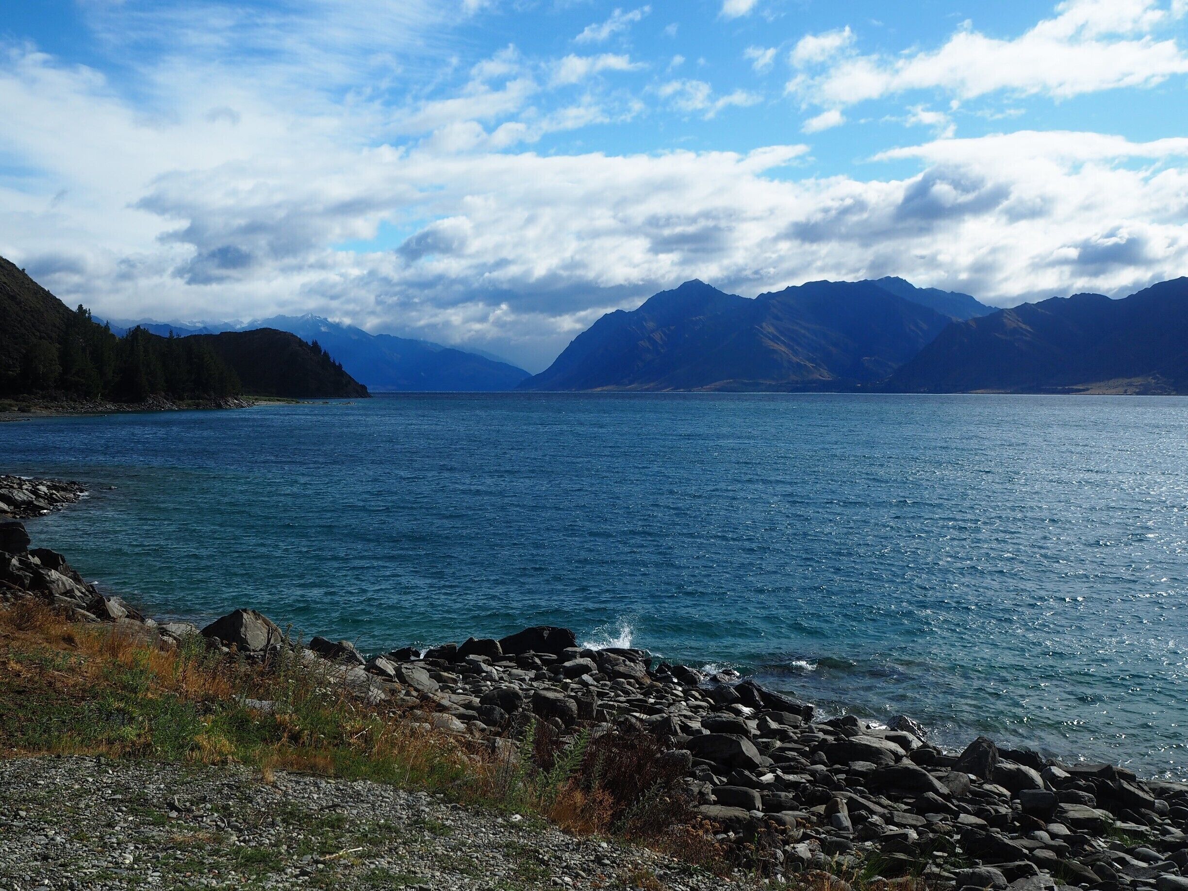 A lake surrounded by mountains and rocky shores.