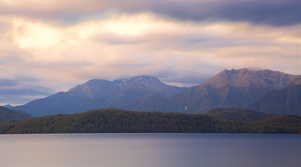 Lake Te Anau which includes a lake or waterhole, mountains and a sunset