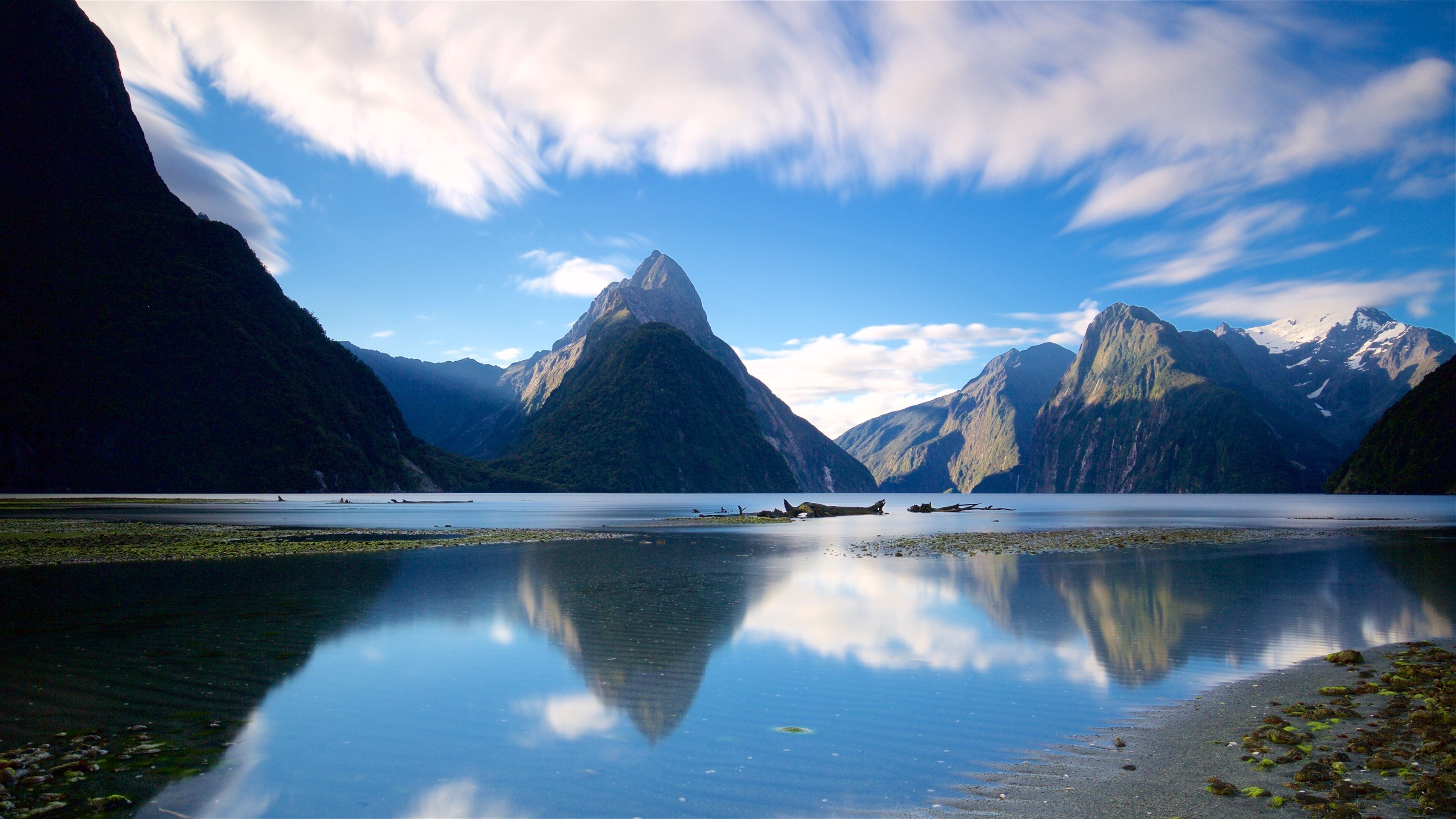 Mitre Peak featuring a lake or waterhole and mountains