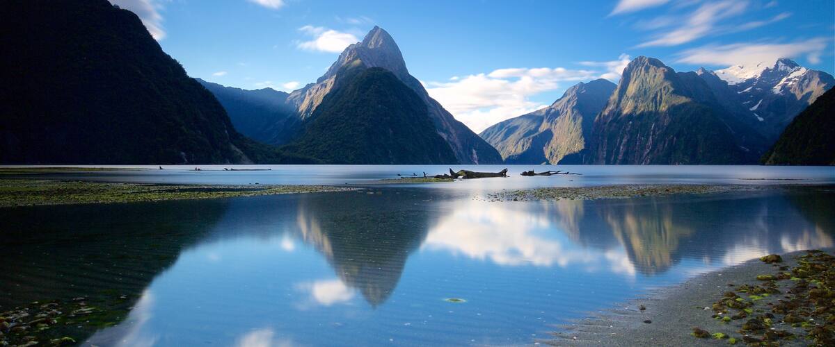 Mitre Peak featuring a lake or waterhole and mountains