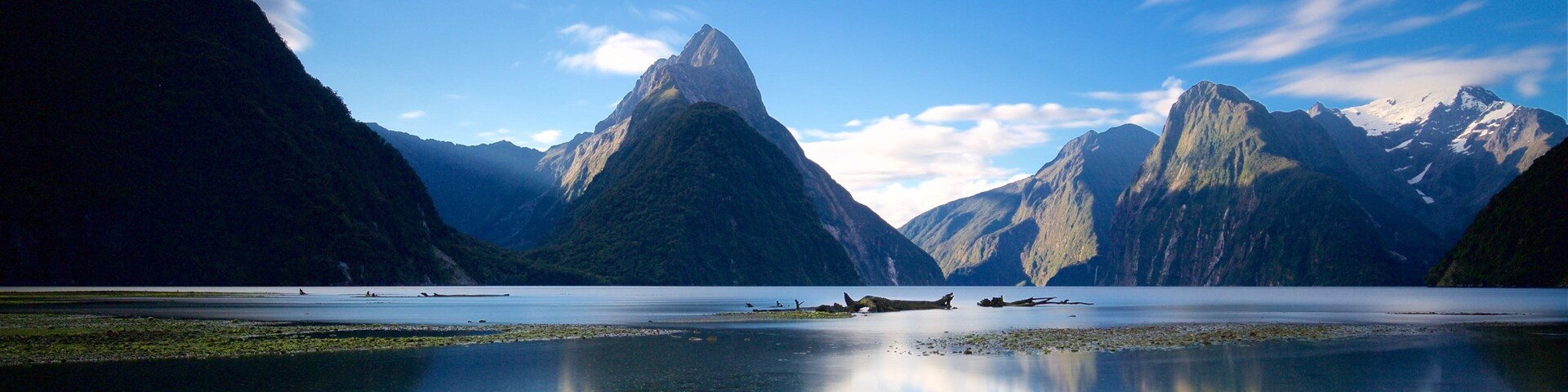 Mitre Peak featuring a lake or waterhole and mountains