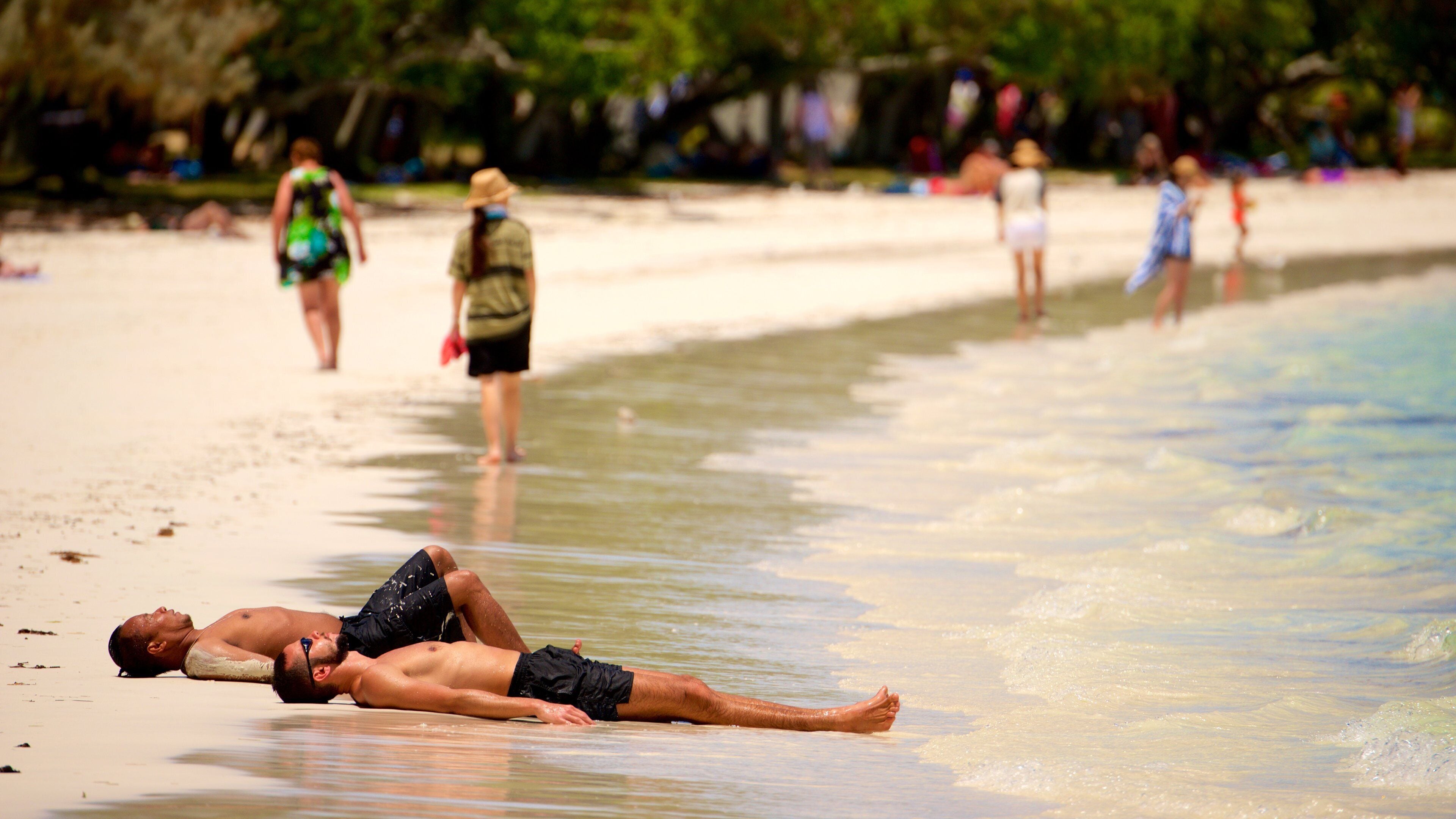 Kuto Beach which includes a sandy beach as well as a small group of people