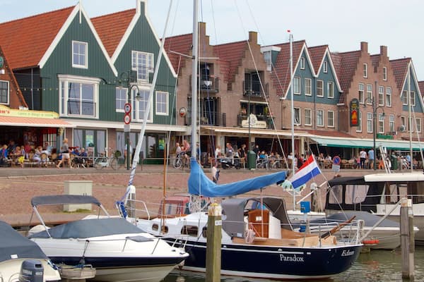 Volendam Harbour showing a coastal town, a bay or harbor and boating