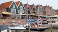 Volendam Harbour showing a coastal town, a bay or harbor and boating