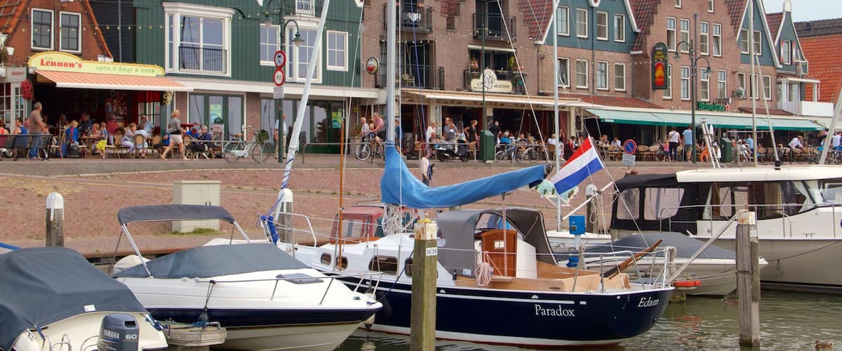 Volendam Harbour showing a coastal town, a bay or harbor and boating