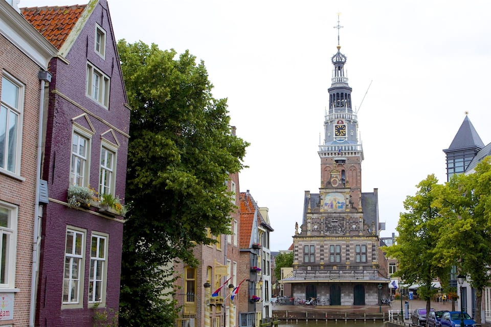 A historic town with a prominent tower, narrow streets, and traditional buildings.