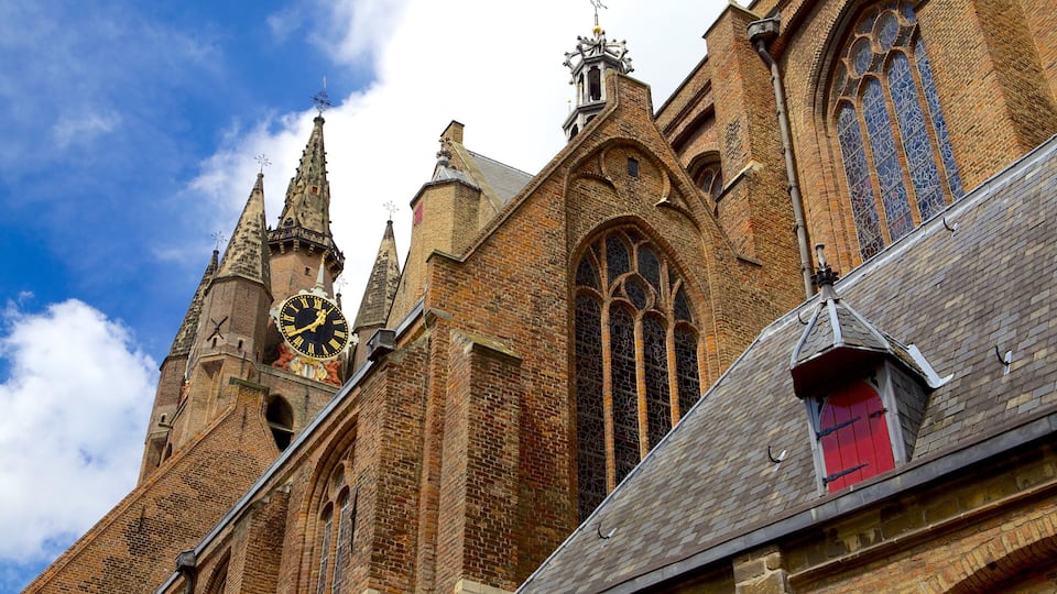 A historic church with a large clock tower and intricate brickwork.