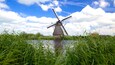 Kinderdijk showing a windmill and a river or creek