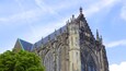A Gothic cathedral with intricate stonework and a pointed roof.