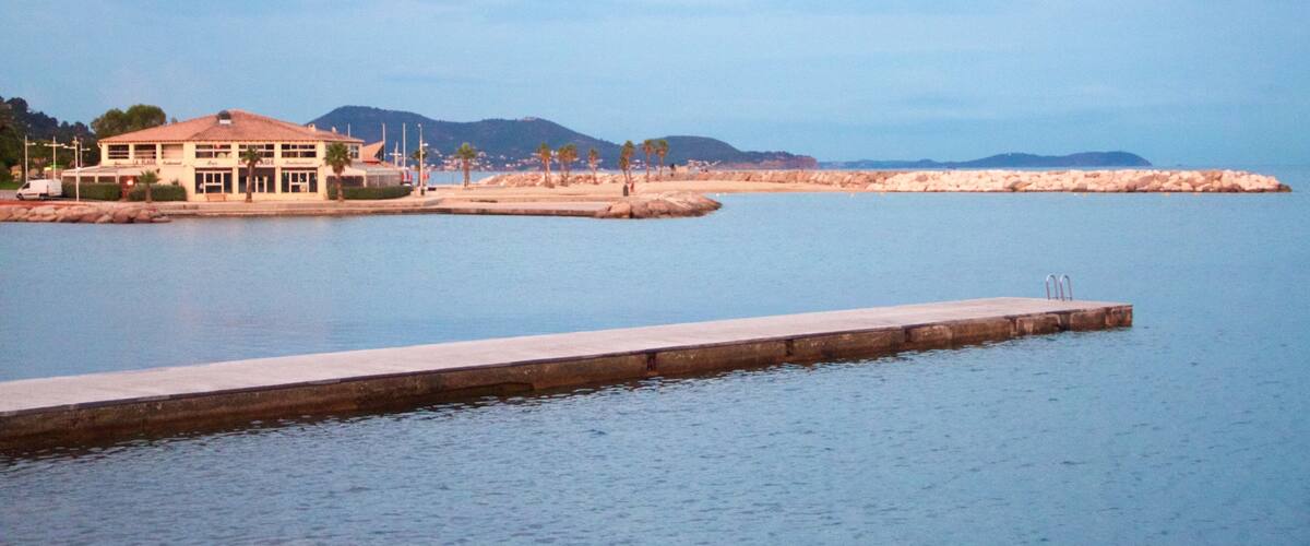 Toulon Beach featuring a bay or harbor, a coastal town and general coastal views