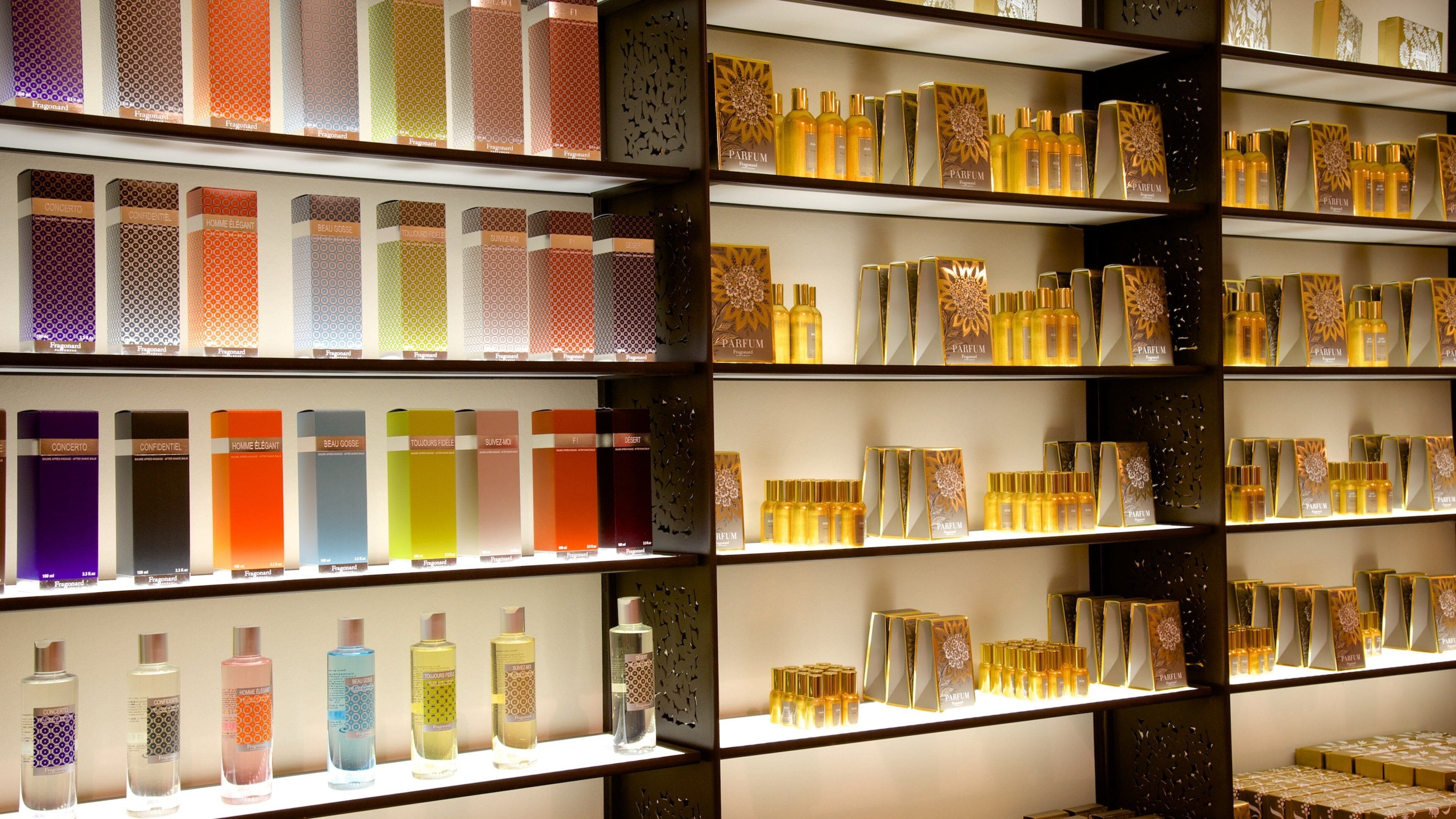 Shelves of perfume bottles and boxes in a store.