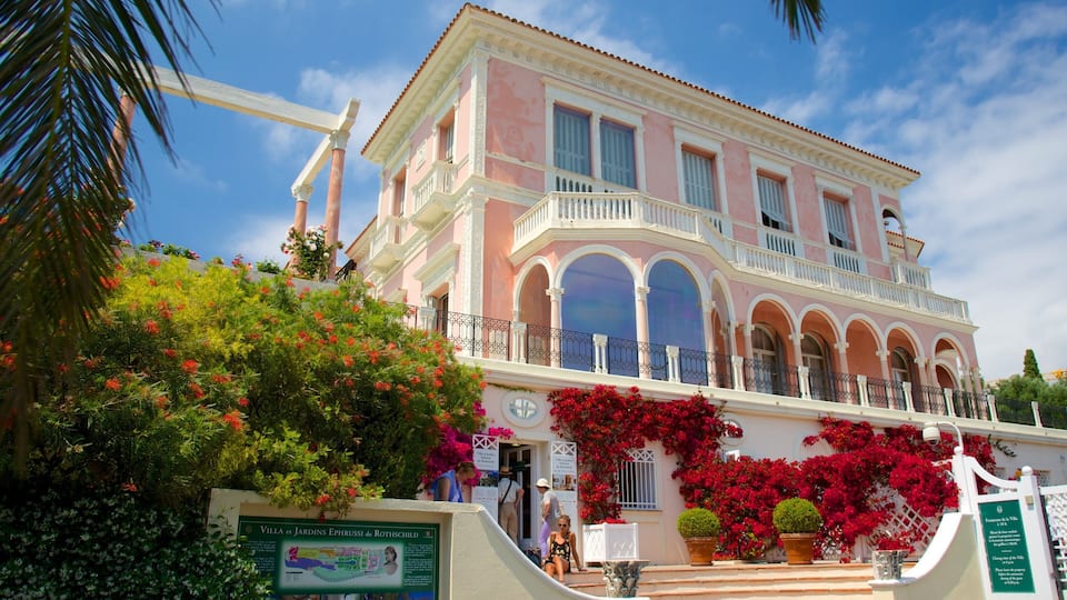 Villa et Jardins Ephrussi de Rothschild with pink and white architecture, arched windows, and lush greenery.