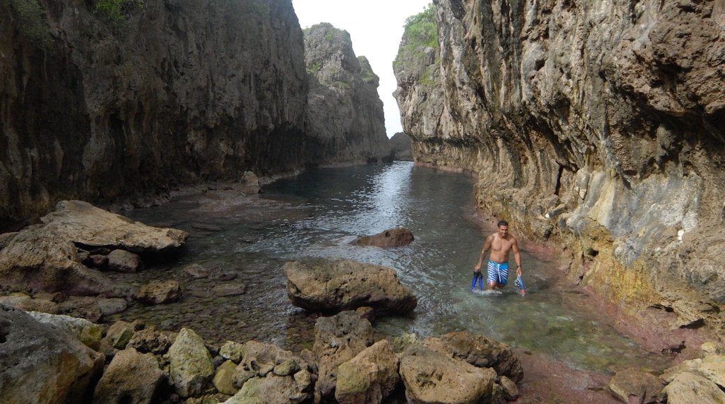 Matapa Chasm featuring a gorge or canyon and rugged coastline as well as an individual male