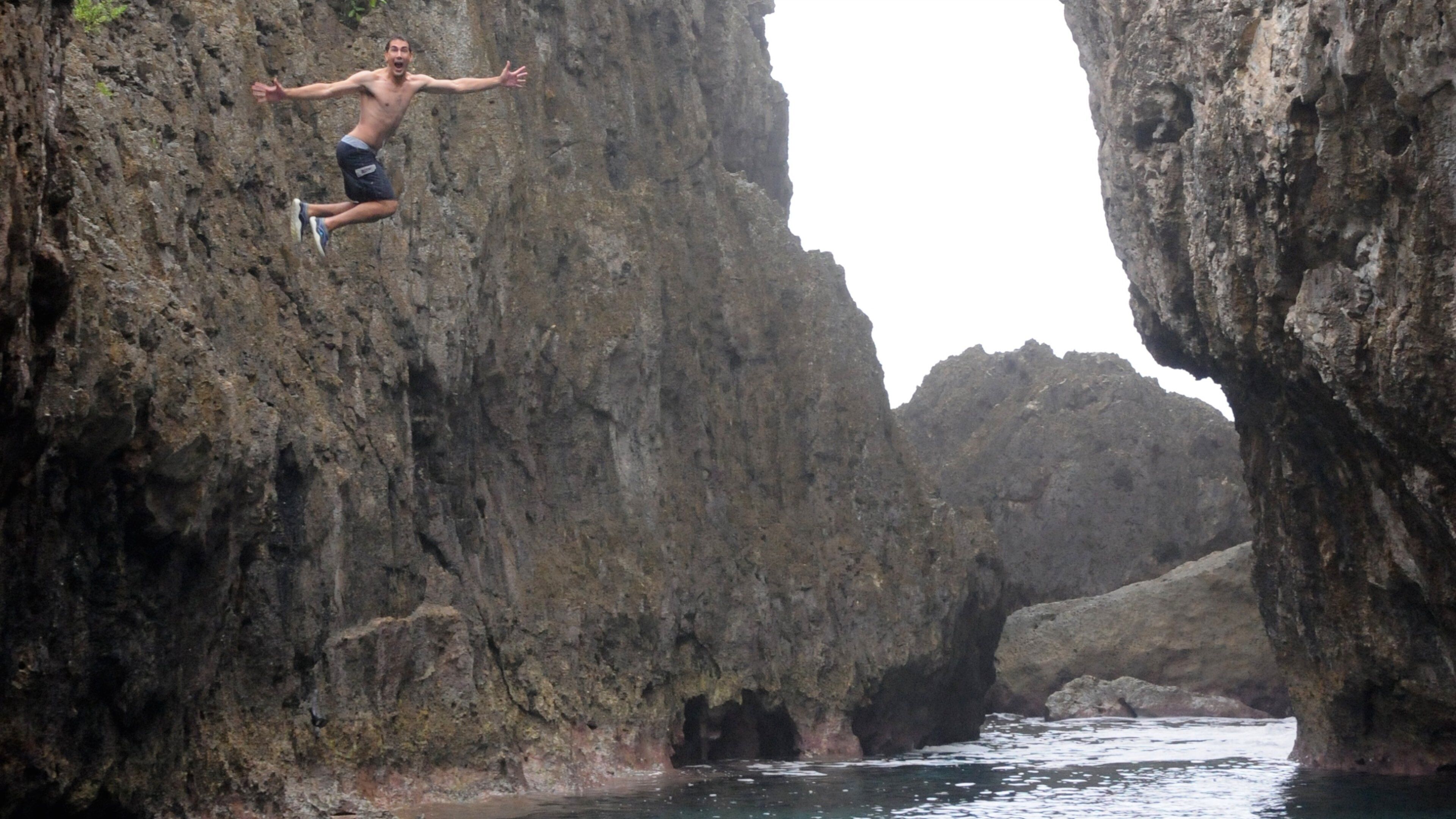 Matapa Chasm which includes a gorge or canyon and rocky coastline as well as an individual male